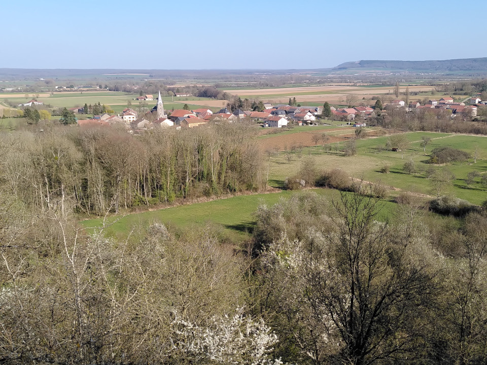 Photo d'un petit village de campagne prise du haut d'une colline.